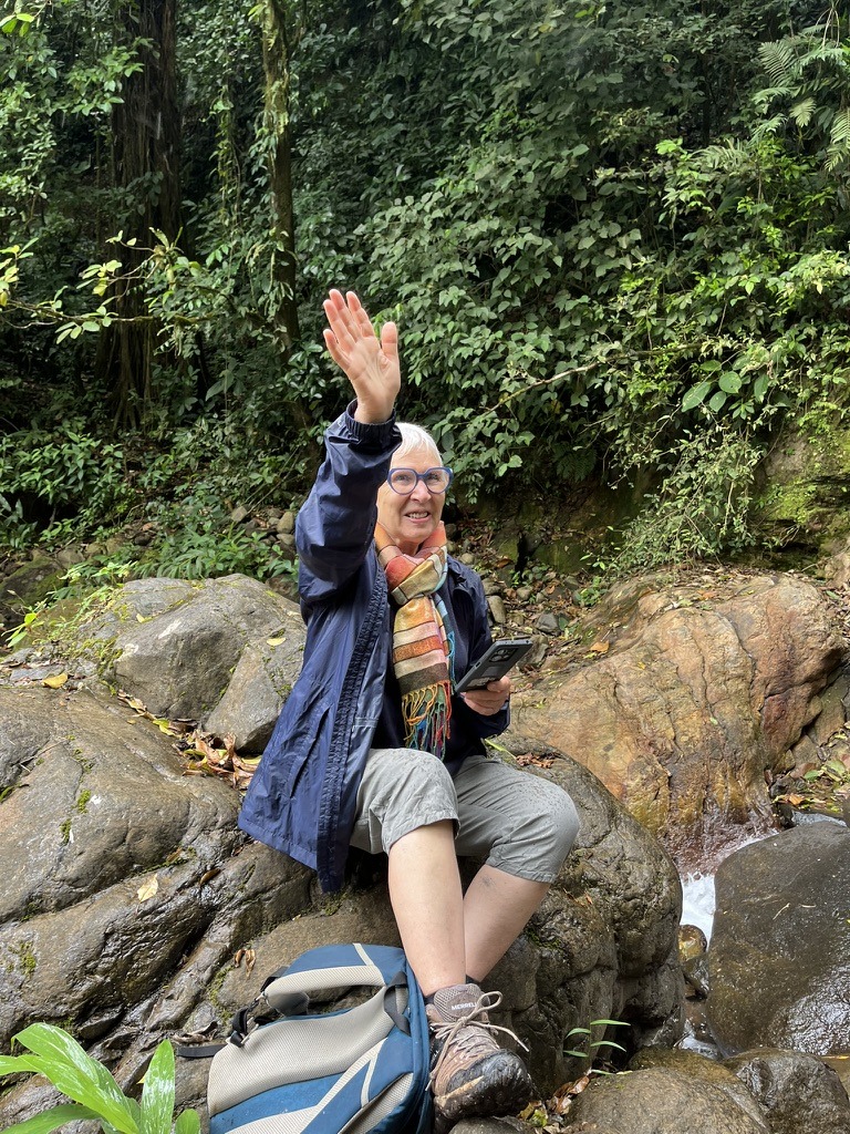 Une voyageuse assise sur une pierre dans une rivière au Costa Rica